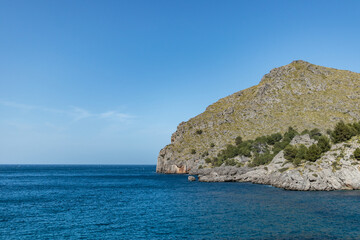 Sunny day over the rocks and the blue water in Sa Calobra, Palma de Mallorca, Balearic Islands, Spain