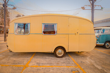 Yellow vintage RV, showing concept of travel and alternative lifestyle