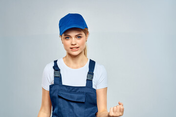 woman in work uniform blue cap service delivery service light background