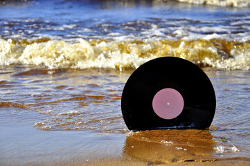 Vinyl record on the sand.