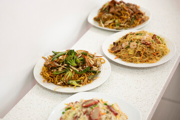 Chinese takeout dishes on white slate.