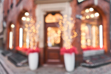 Abstract blur. Street in a Christmas day in an old European town. Lamps garlands, christmas decor and decorations