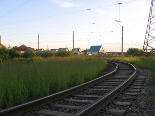Fototapeta premium tram rails laid lead to houses in a residential area
