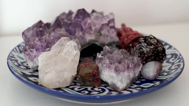 Holistic round plate filled with various crystals (Purple Amethyst, White Quartz, Bornite/Chalcopyrite) and Incense