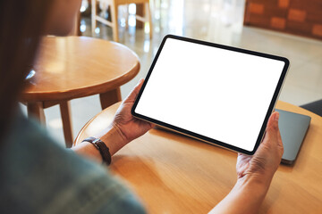 Mockup image of a woman holding digital tablet with blank white desktop screen