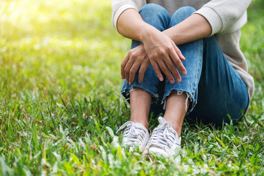 Closeup image of a woman sitting and relaxing in the park