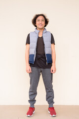 Full body shot of happy Japanese man with curly hair smiling