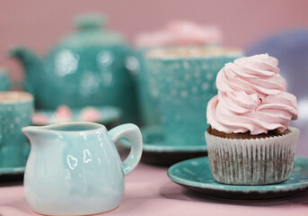 Still life. Cupcake with a cap of cream with blue utensils