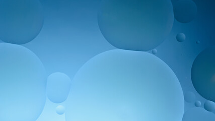 oil with bubbles on on dark blue background. Abstract background.