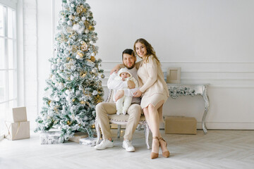 Christmas family portrait in your home a festive living room, the parents and the child