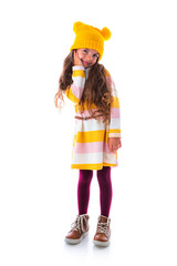 Happy beautiful young girl with colourful clothes posing in studio, portrait on white background