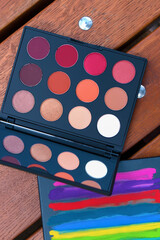 
two makeup palettes on wooden background, closeup