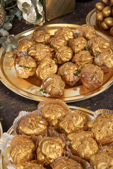 festive eclairs decorated with liquid gold served on a Golden plate