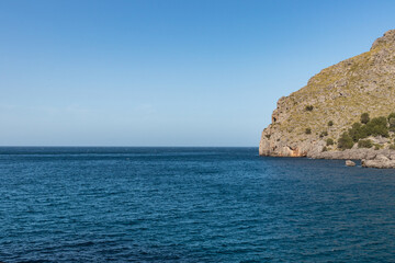 Fototapeta premium Sunny day over the rocks and the blue water in Sa Calobra, Palma de Mallorca, Balearic Islands, Spain