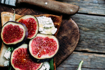 Toast with cream cheese, figs and honey on the table