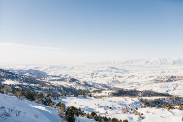 Panorama of the Tien Shan mountains covered with snow in Sunny weather. Winter landscape in the mountains of the Beldersay ski resort
