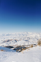 Obraz premium Beautiful panoramic view of snow covered mountains. The best view from the Beldersay cable-way
