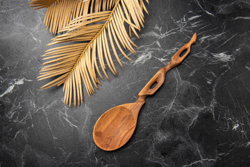 wooden spoon on black marble in the kitchen
