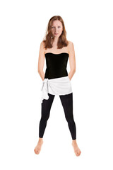 Fit brunette woman wearing black leggings and top, full length portrait isolated in front of white studio background