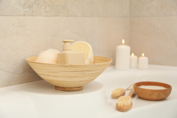 Bath with personal hygiene accessories in light beige bathroom