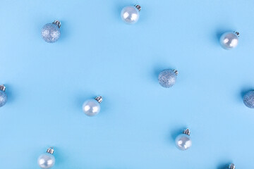 Blue Christmas balls pattern. Beautiful Christmas holiday decorations in contemporary trendy blue colors on blue background. Flat lay, copy space, top view. Winter holidays, New Year. Merry Christmas 