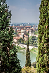 Fototapeta na wymiar Beautiful views of Verona, the Adige river, bridges and cathedrals from the observation deck at St. Peter's castle. Verona, Veneto, Italy