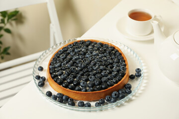 Concept of tasty breakfast with blueberry pie on white table