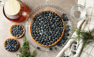 Concept of tasty lunch with blueberry pie on gray table