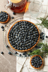 Fototapeta na wymiar Concept of tasty lunch with blueberry pie on gray table
