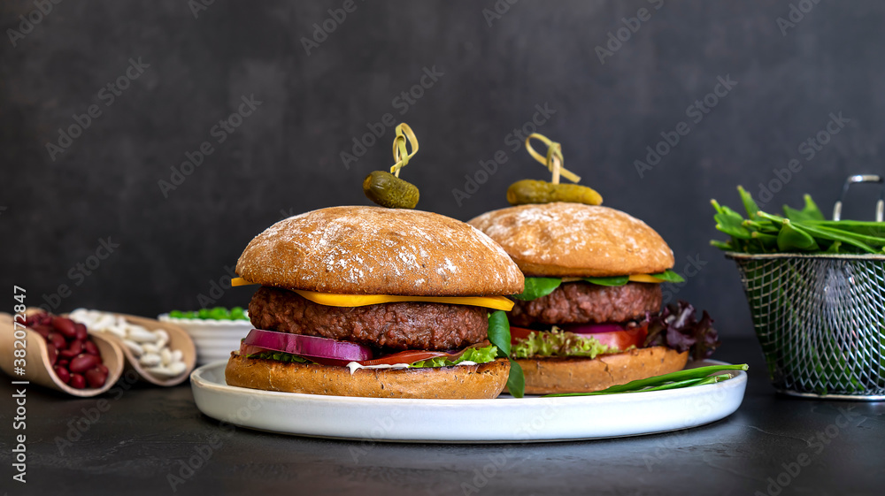 Wall mural vegan burger made of beans, beetroot, and peas with vegan cheese and pickles. homemade healthy recip