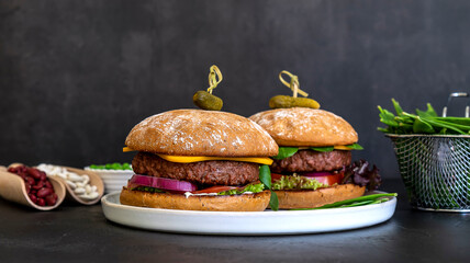 Vegan burger made of beans, beetroot, and peas with vegan cheese and pickles. Homemade healthy recipe.