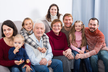 Fototapeta premium Smiling family making numerous photos during family dinner