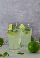Refreshing alcoholic mint cocktail mojito with rum and lime, cold drink or beverage with ice. Vertical orientation.