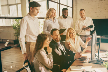 Photo of smart group expert marketers coaching sit table work computer analyze crisis way out...