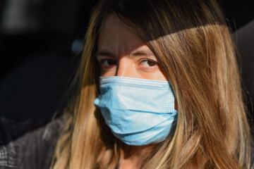 woman wears a medical mask because air pollution or virus is an epidemic in the city. Breathing...