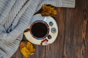 warming autumn drink a cup of coffee, a warm sweater, autumn decor with copy space