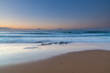 Fototapeta na wymiar Soft and pretty blue winter sunrise seascape with fog on the horizon