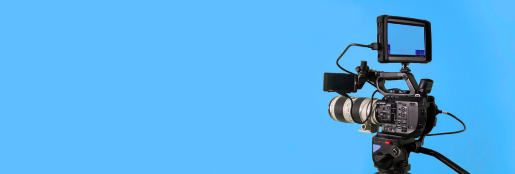 Video camera on blue background, broadcasting banner with copy space
