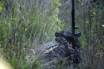 A soldier in a fighting position in cover.