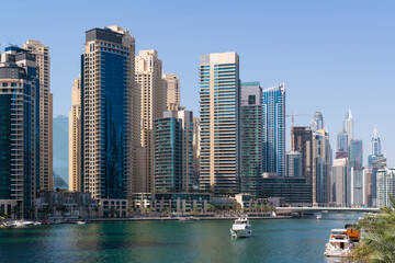 Fototapeta na wymiar Panoramic view of skyscrapers of Dubai Marina at a sunny day. Modern cityscape of the capital of the Emirate of Dubai. Business hub of international trading and financial services of Western Asia