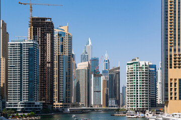 Fototapeta na wymiar Panoramic view of steel and glass skyscrapers of Dubai Marina at a sunny day. Modern cityscape of the capital of the Emirate of Dubai. Financial services hub of Western Asia