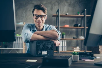 Fotobehang Portrait of his he nice attractive cheerful cheery confident geek guy top tech manager remote part-time building process teamwork at modern concrete wall interior style work place station indoors © deagreez