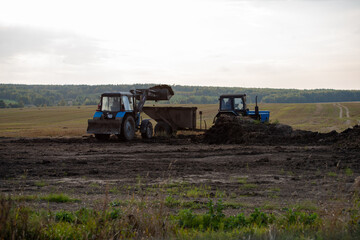 Naklejka premium agricultural machines at work in the field