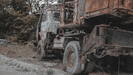 Fototapeta na wymiar Old, rusty, abandoned truck crane in the woods. Old, rusty interior elements, controls and indicators.