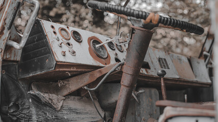 Old, rusty, abandoned truck crane in the woods. Old, rusty interior elements, controls and indicators. Interior close-up.