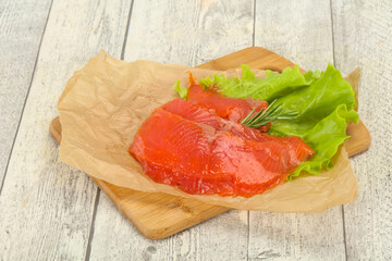 Sliced salmon fillet served rosemary