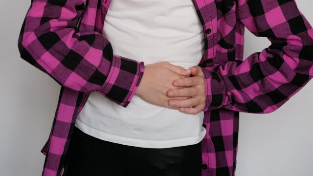 Little / young girl holding her stomach to the left, colic, upset stomach