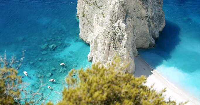 Zakynthos island, Greece. White rock near Keri with blue lagoon, tourist pleasure boats on secluded beach. Top view.
