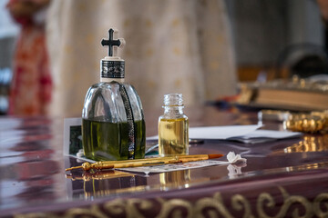Closeup shot of holy water and oil on a bible