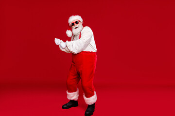 Fototapeta na wymiar Full length body size view of his he handsome cheerful funny positive bearded Santa hipster dancing having fun wearing festal outfit sunglasses isolated bright vivid shine vibrant red color background